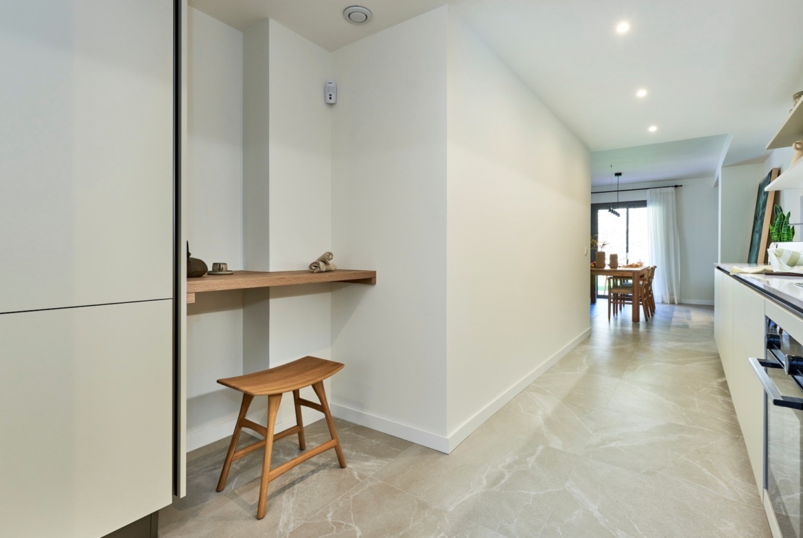 Widok z kuchni na jadalnię; długi korytarz, zabudowa kuchenna i naturalne światło – ES Voltor, Esporles.