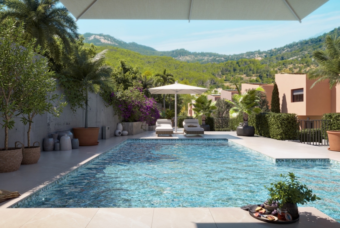 Basen osiedlowy z leżakami i zielenią w inwestycji ES Voltor w Esporles.