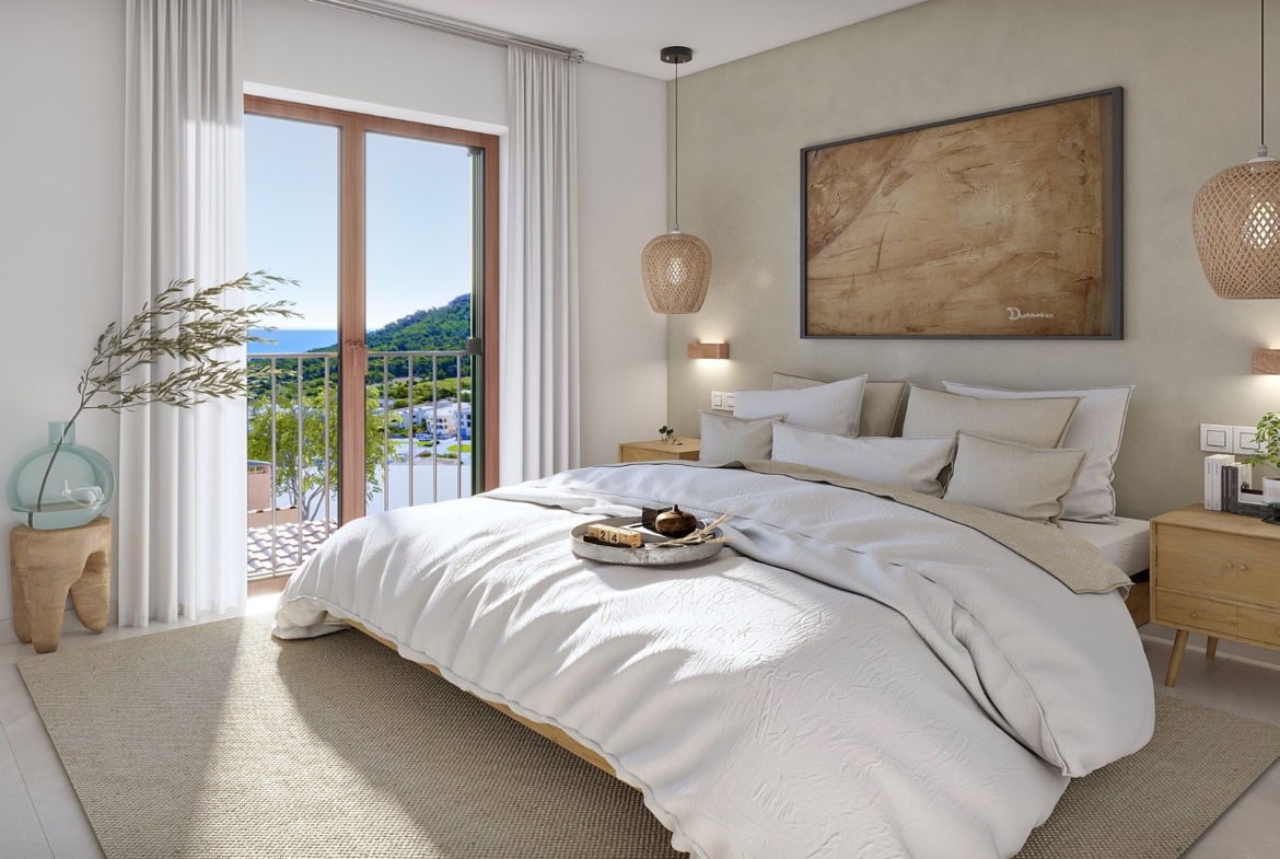 Sypialnia z dostępem do balkonu w Oli (Taylor Wimpey) w Capdepera – widok na wzgórza i morze.