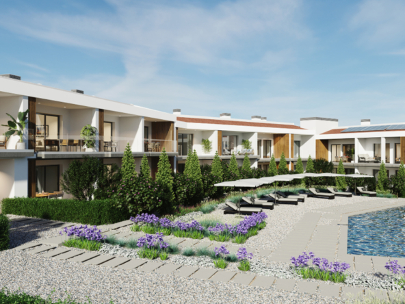 Strefa basenowa na dziedzińcu osiedla z leżakami i zielenią.